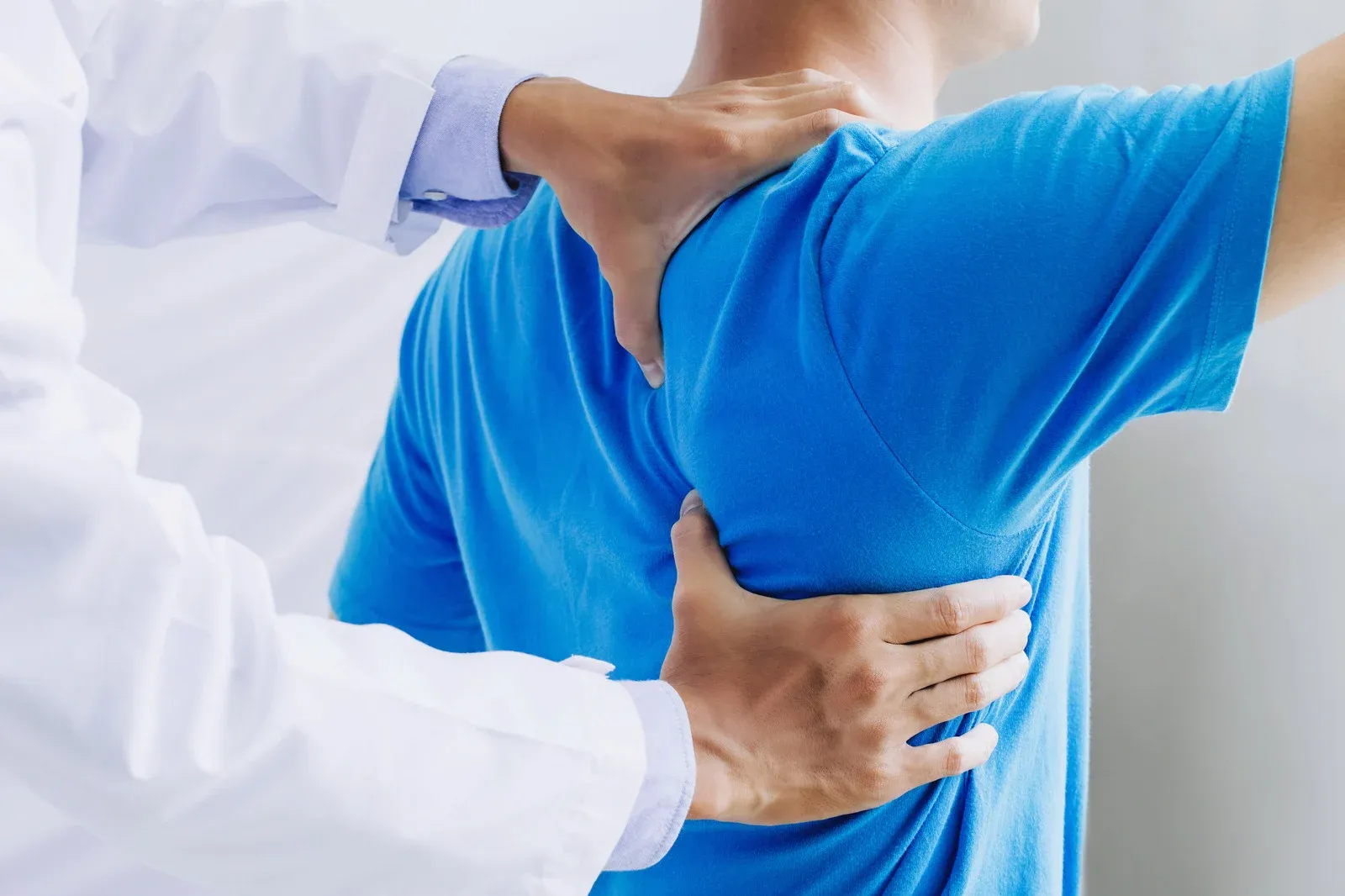 Doctor Evaluating Male Patient Back & Spine